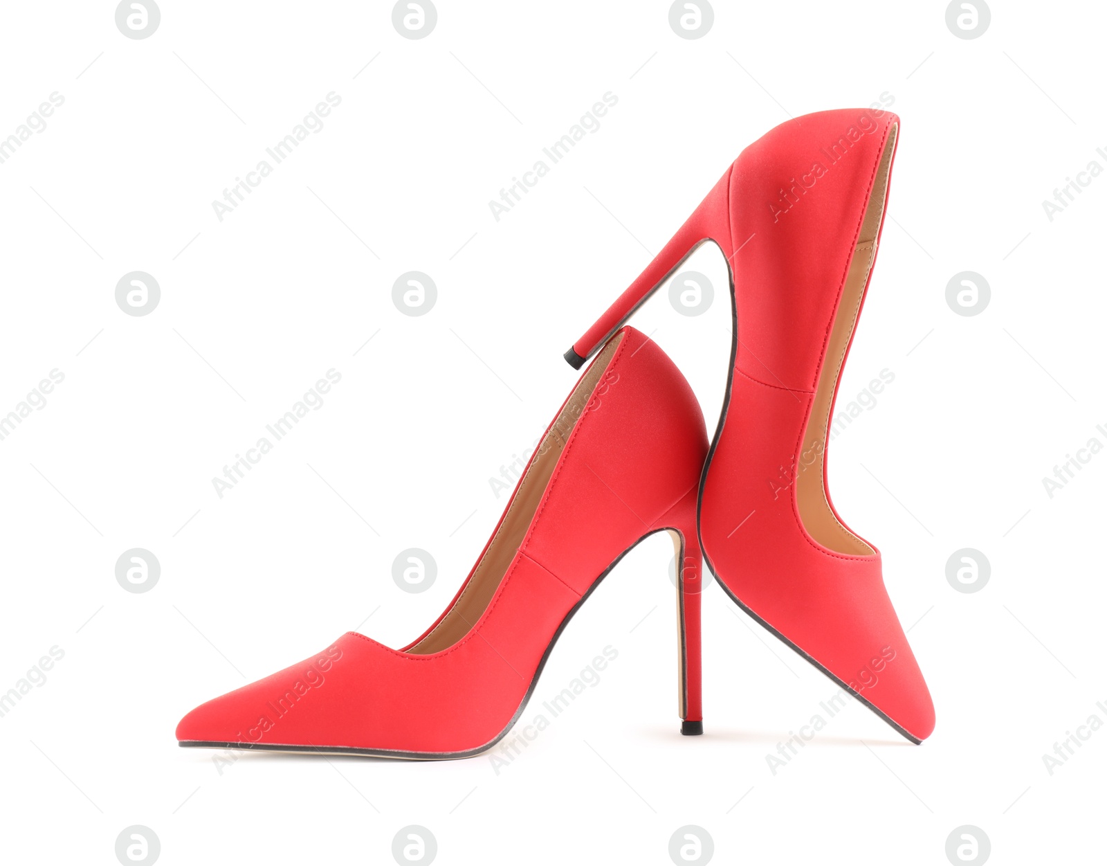 Photo of Pair of red high-heeled shoes isolated on white