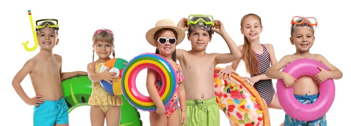 Happy children in swimwear with beach items on white background