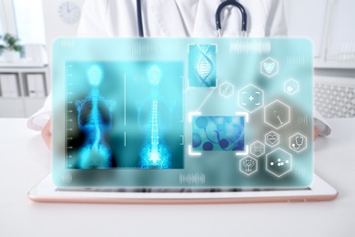 Image of Medical technology. Doctor using tablet with virtual screen, closeup. Icons, illustration of human skeleton and DNA