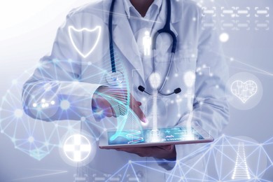 Medical technology. Doctor using tablet, closeup. Different digital healthcare elements