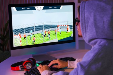 Photo of Woman playing video game with keyboard at table indoors