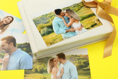 Photo album with different photos and ribbon on yellow background, closeup