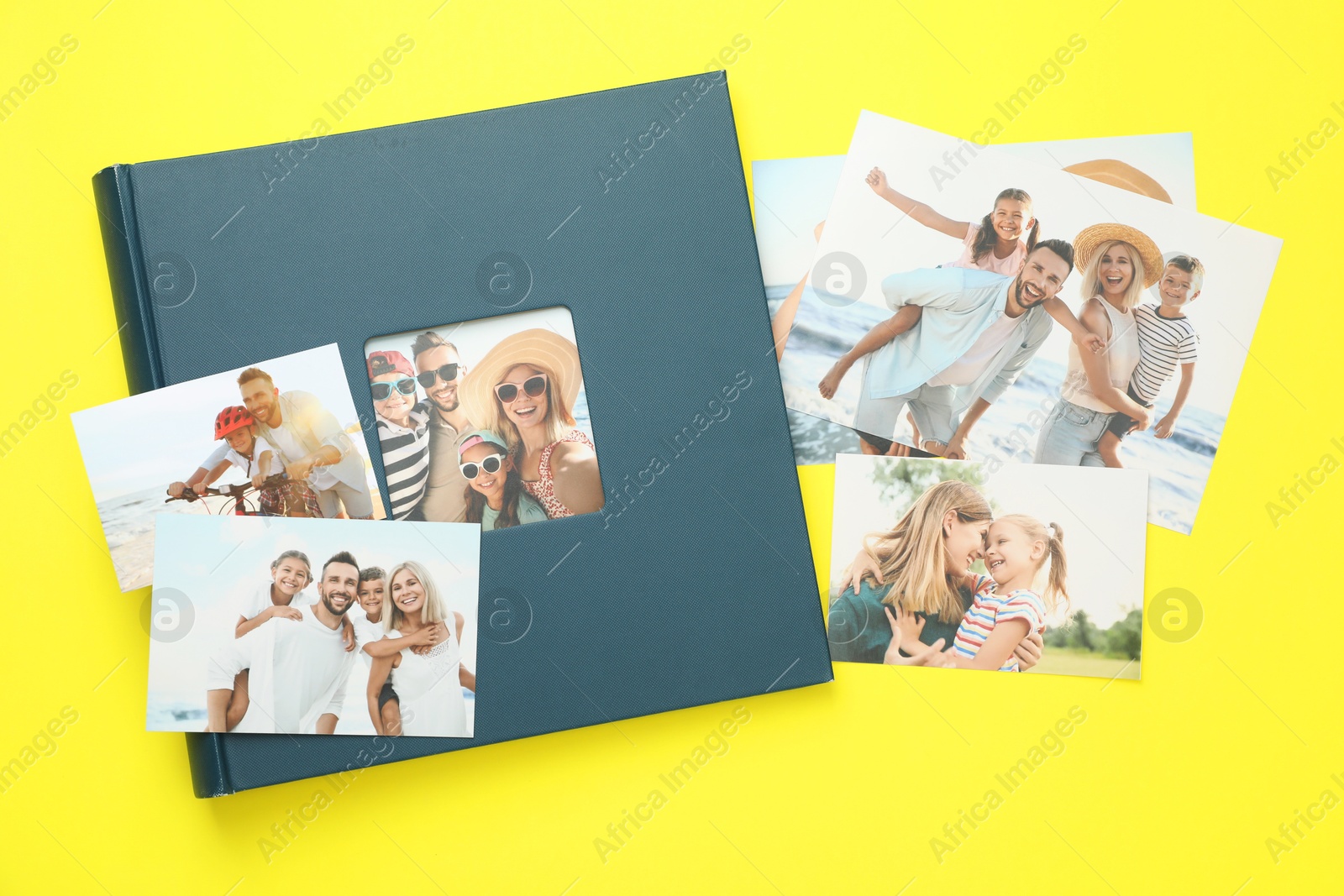 Photo of Photo album with different photos on yellow background, top view