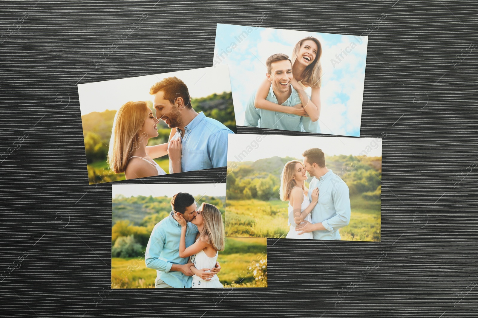 Photo of Different family photos on black wooden table, flat lay