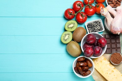 Photo of Different products rich in serotonin on light blue wooden table, flat lay. Space for text