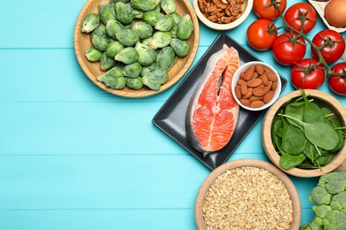 Photo of Different fresh products rich in melatonin on light blue wooden table, flat lay. Space for text