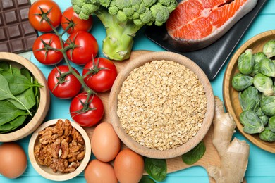 Photo of Different fresh products rich in melatonin on light blue wooden table, flat lay