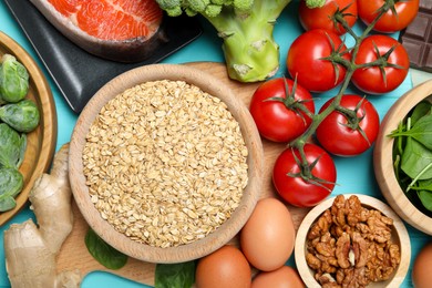 Photo of Different fresh products rich in melatonin on light blue table, flat lay