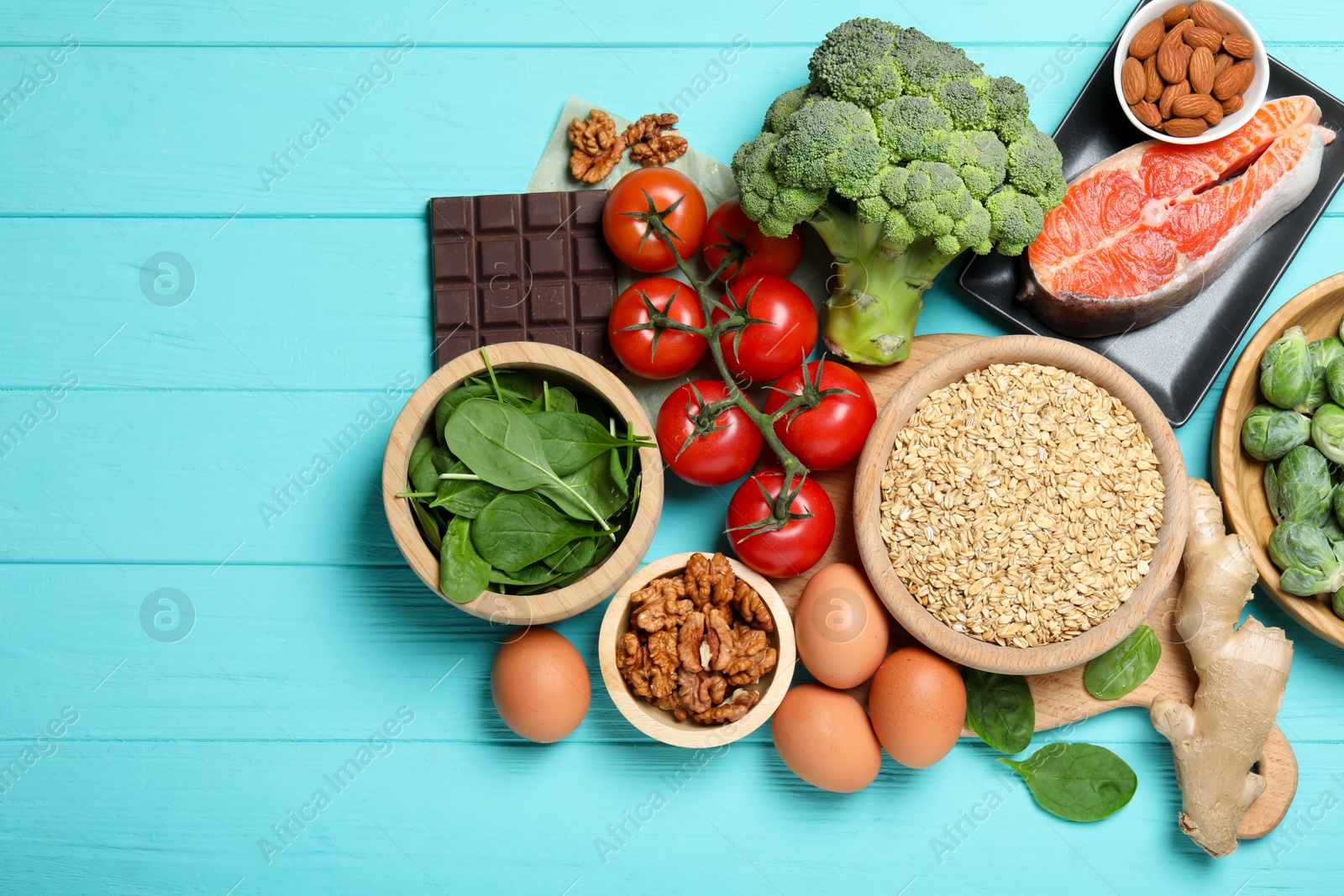 Photo of Different fresh products rich in melatonin on light blue wooden table, flat lay. Space for text