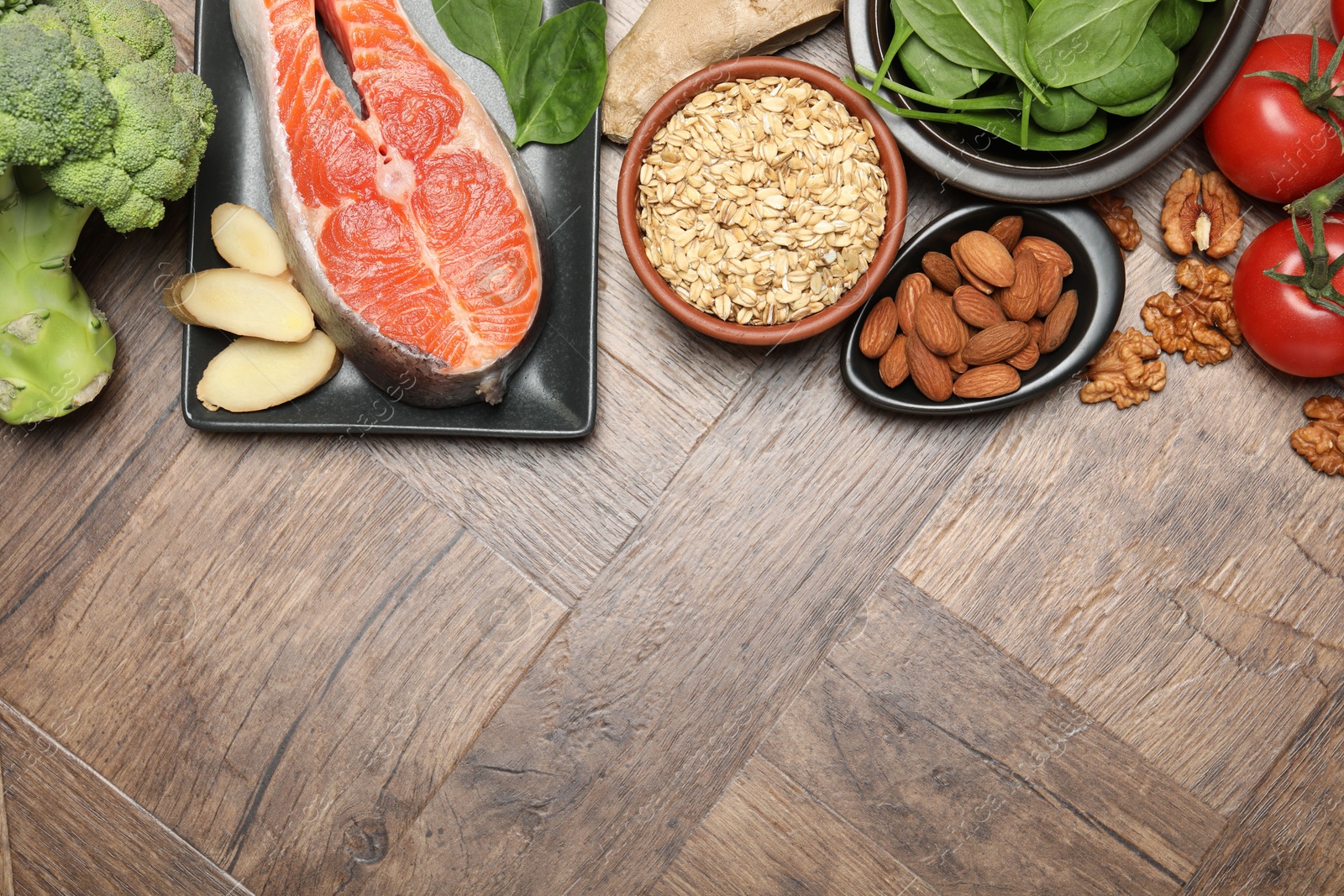 Photo of Different fresh products rich in melatonin on wooden table, flat lay. Space for text