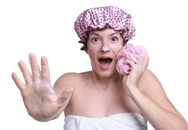 Photo of Woman with shower cap and mesh sponge making stop gesture on white background