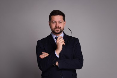 Photo of Portrait of banker with glasses on grey background