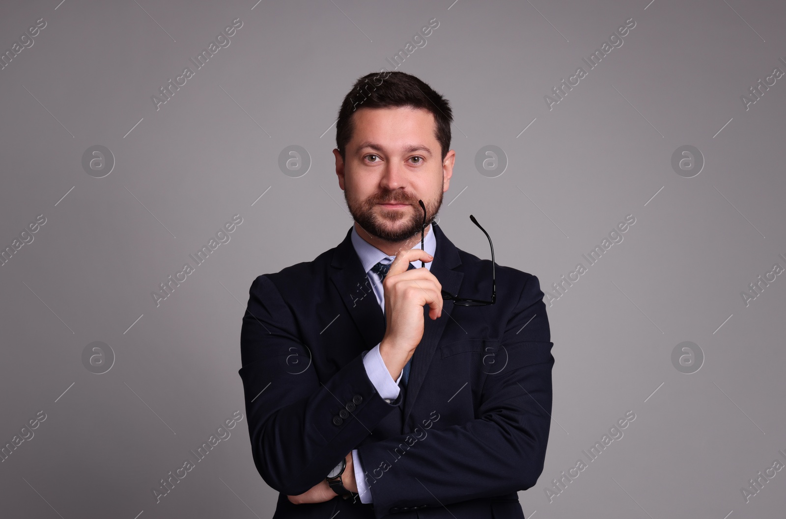 Photo of Portrait of banker with glasses on grey background