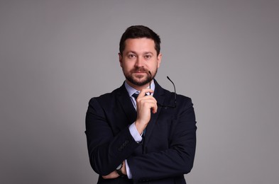 Photo of Portrait of banker with glasses on grey background