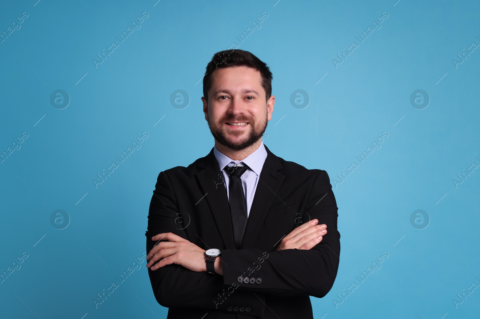 Photo of Banker with crossed arms on light blue background