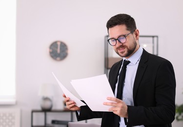 Photo of Portrait of banker with documents in office, space for text