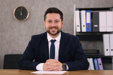 Photo of Portrait of banker at wooden table in office