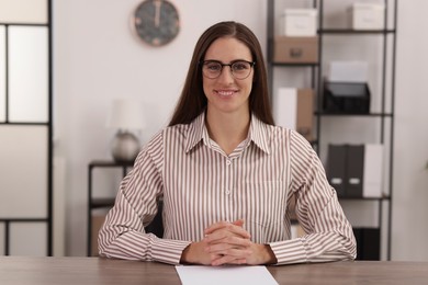 Photo of Portrait of banker at wooden table in office