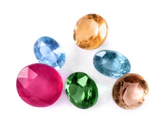 Photo of Different colorful shiny gemstones isolated on white