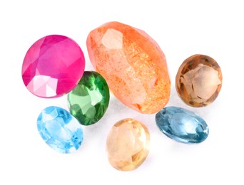 Photo of Different colorful shiny gemstones isolated on white