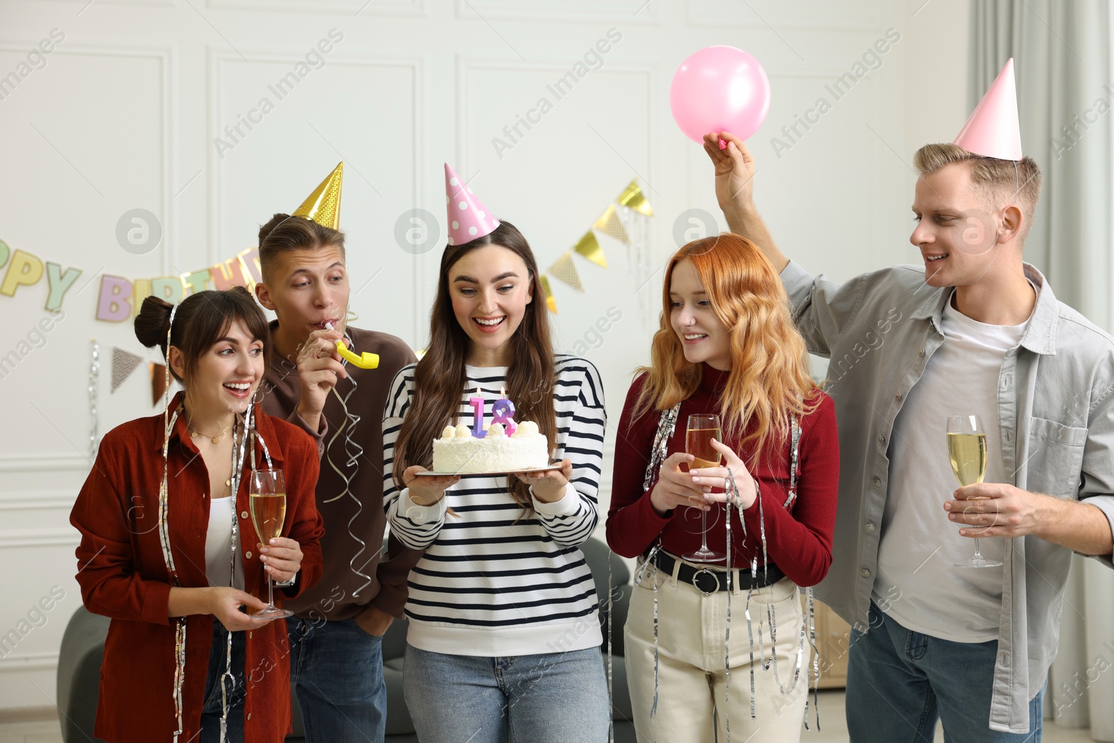 Photo of 18th birthday. Group of happy friends with tasty cake having coming of age party at home