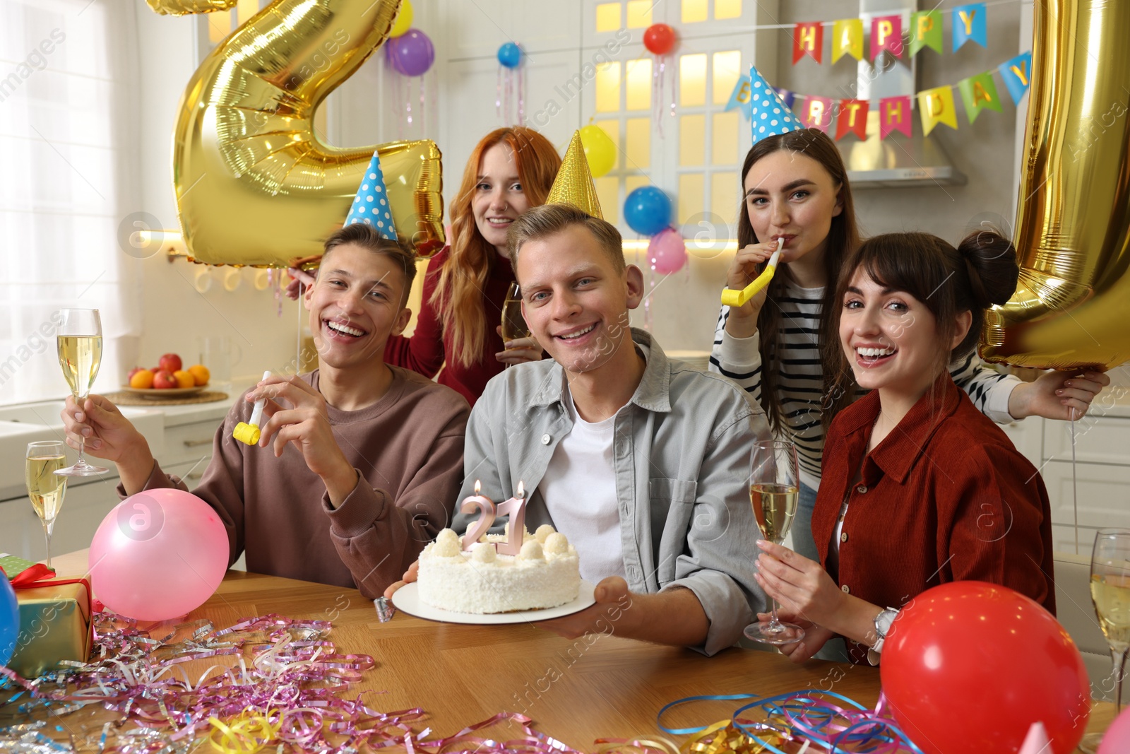 Photo of 21st birthday. Group of happy friends with tasty cake having coming of age party at home