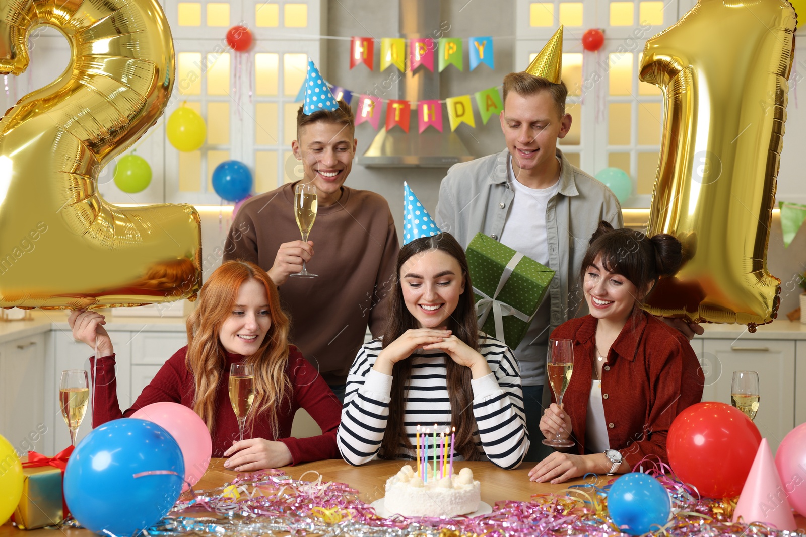 Photo of 21st birthday. Group of happy friends with tasty cake having coming of age party at home