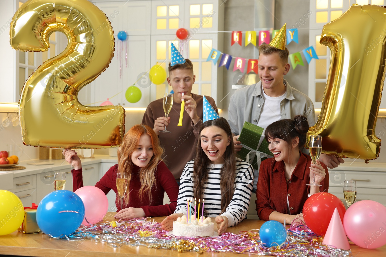 Photo of 21st birthday. Group of happy friends with tasty cake having coming of age party at home