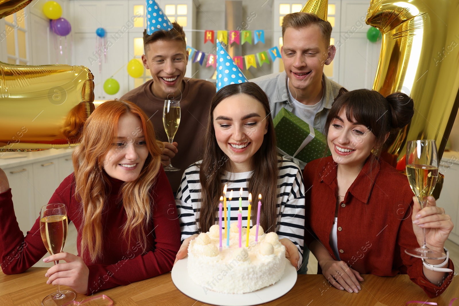 Photo of 21st birthday. Group of happy friends with tasty cake having coming of age party at home