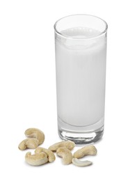 Photo of Fresh cashew milk in glass and nuts isolated on white