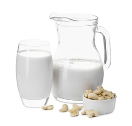 Photo of Fresh cashew milk in glass, jug and nuts isolated on white