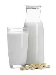 Photo of Fresh cashew milk in glass, carafe and nuts isolated on white