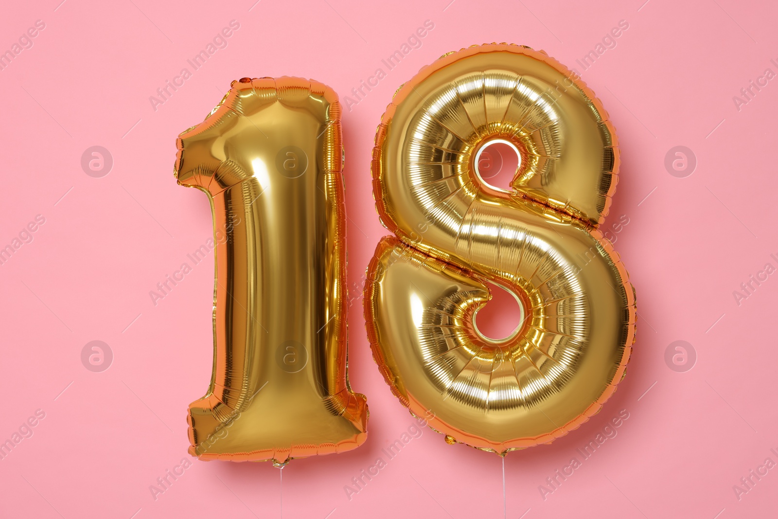 Photo of 18th birthday, coming of age party. Number shaped balloons on pink background