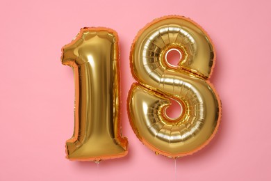 Photo of 18th birthday, coming of age party. Number shaped balloons on pink background