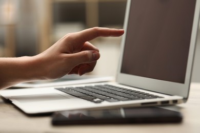 Photo of Businessman using laptop at table, closeup. Modern technology