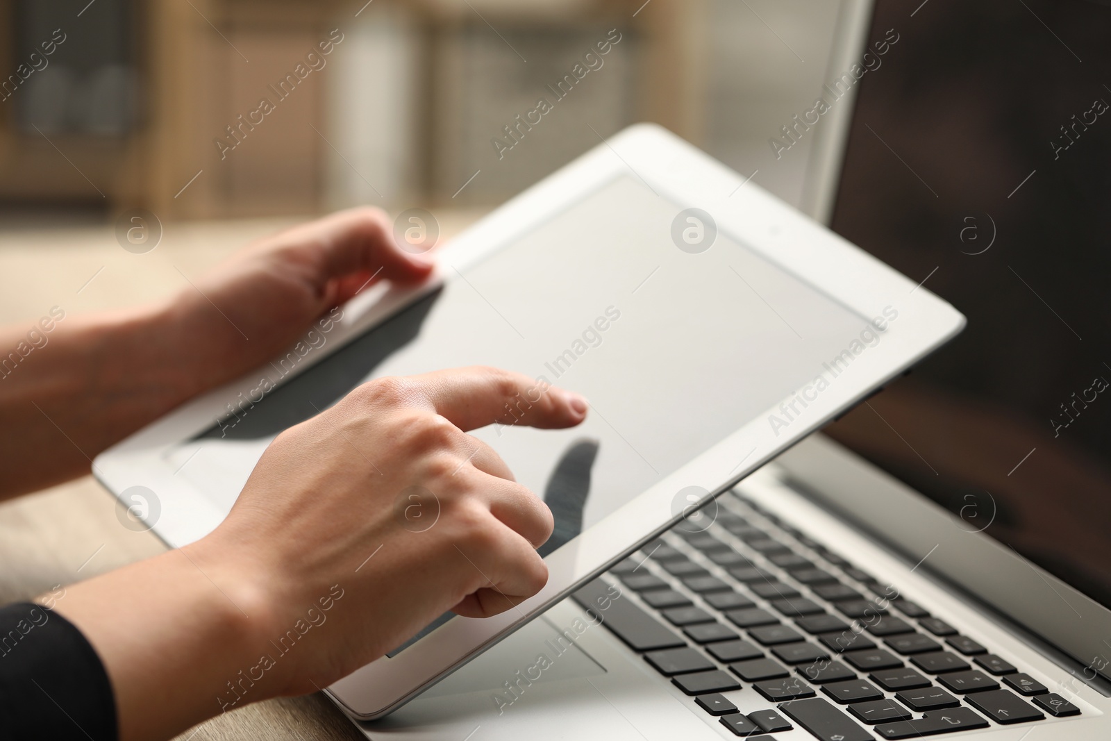 Photo of Businessman using tablet at table, closeup. Modern technology