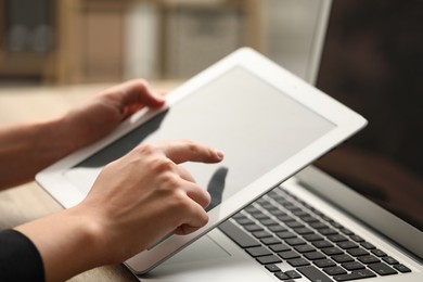 Photo of Businessman using tablet at table, closeup. Modern technology