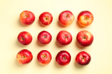 Many red apples on beige background, flat lay