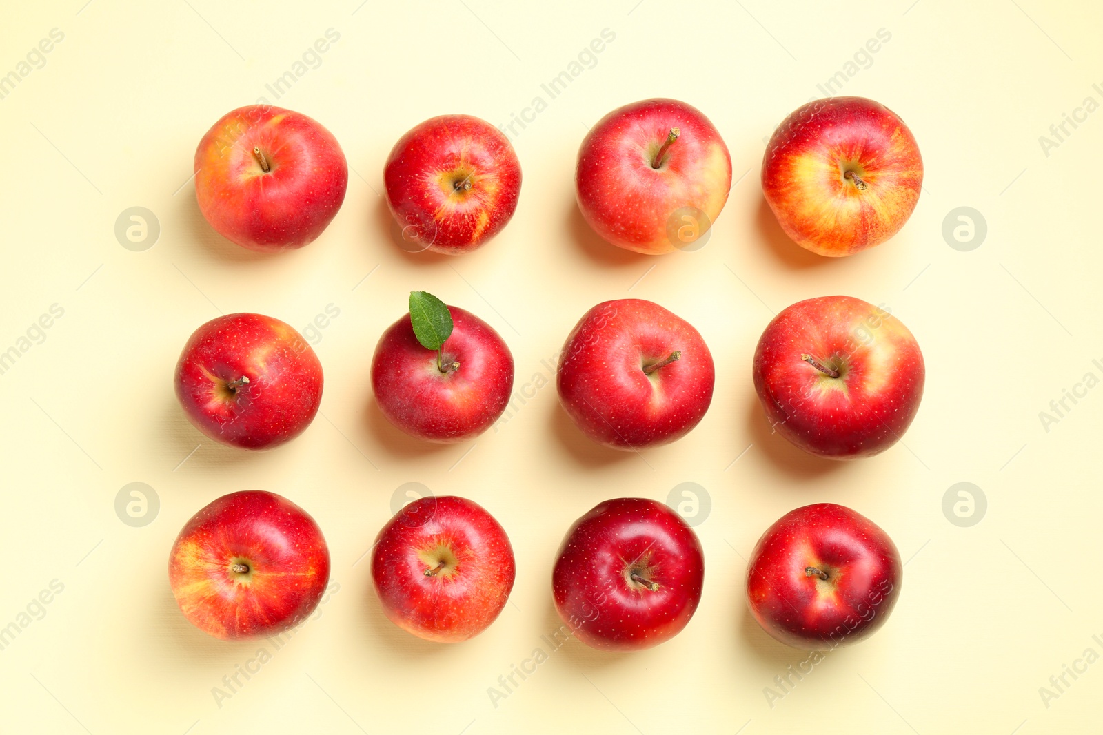 Photo of Many red apples on beige background, flat lay