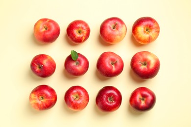 Photo of Many red apples on beige background, flat lay