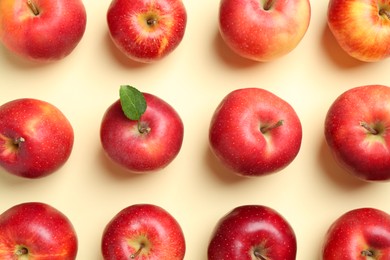 Photo of Many red apples on beige background, flat lay