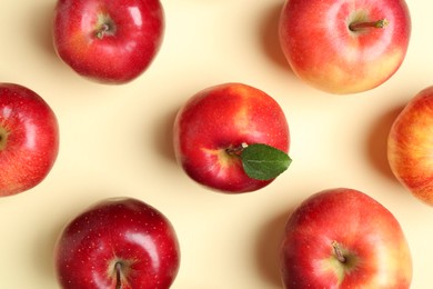 Many red apples on beige background, flat lay