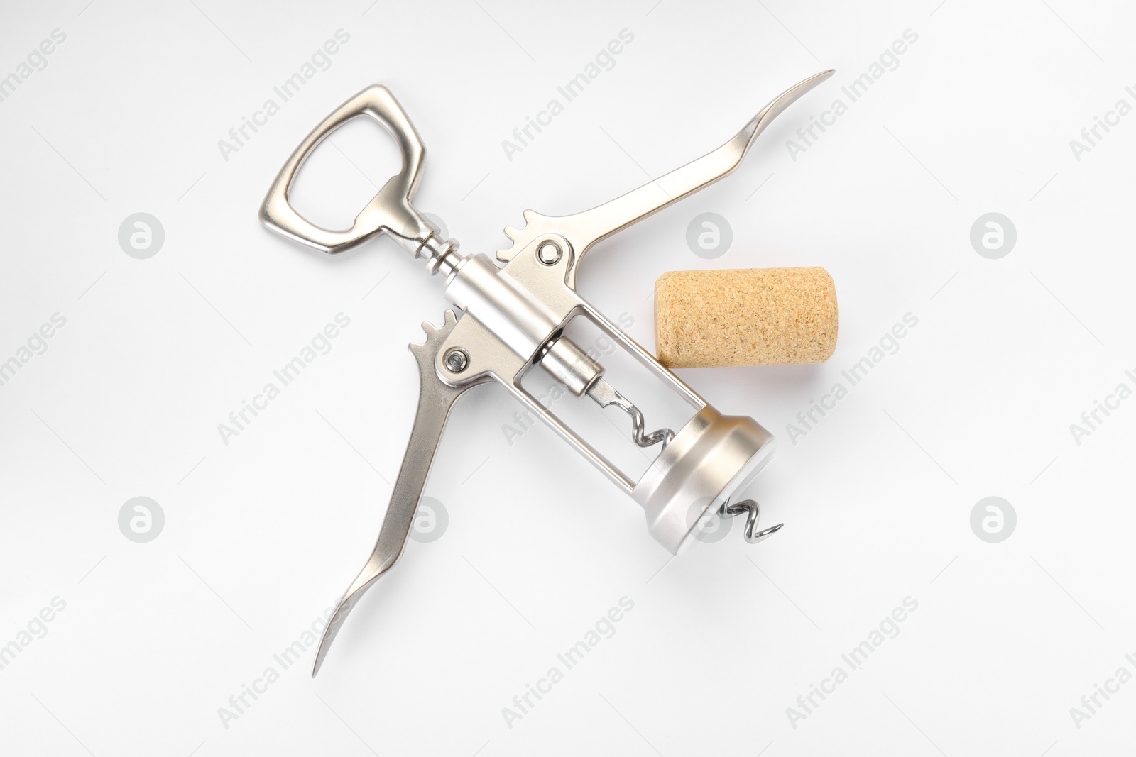 Photo of Wing corkscrew and cork on white background, top view