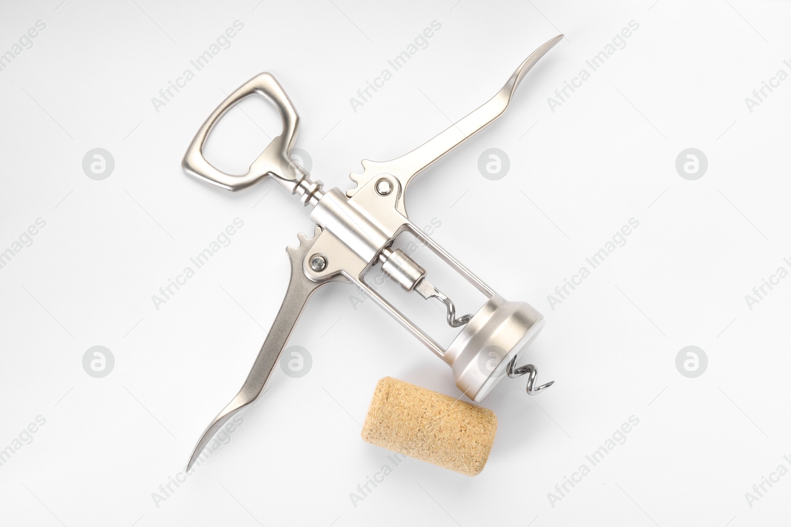 Photo of Wing corkscrew and cork on white background, top view