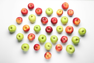 Red and green apples on white background, flat lay