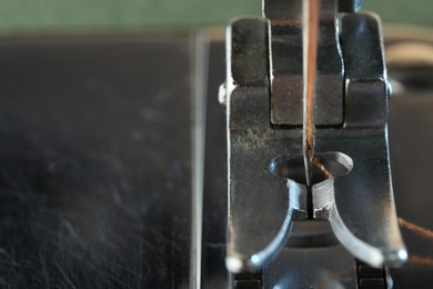 Photo of Sewing machine with thread, macro view. Space for text