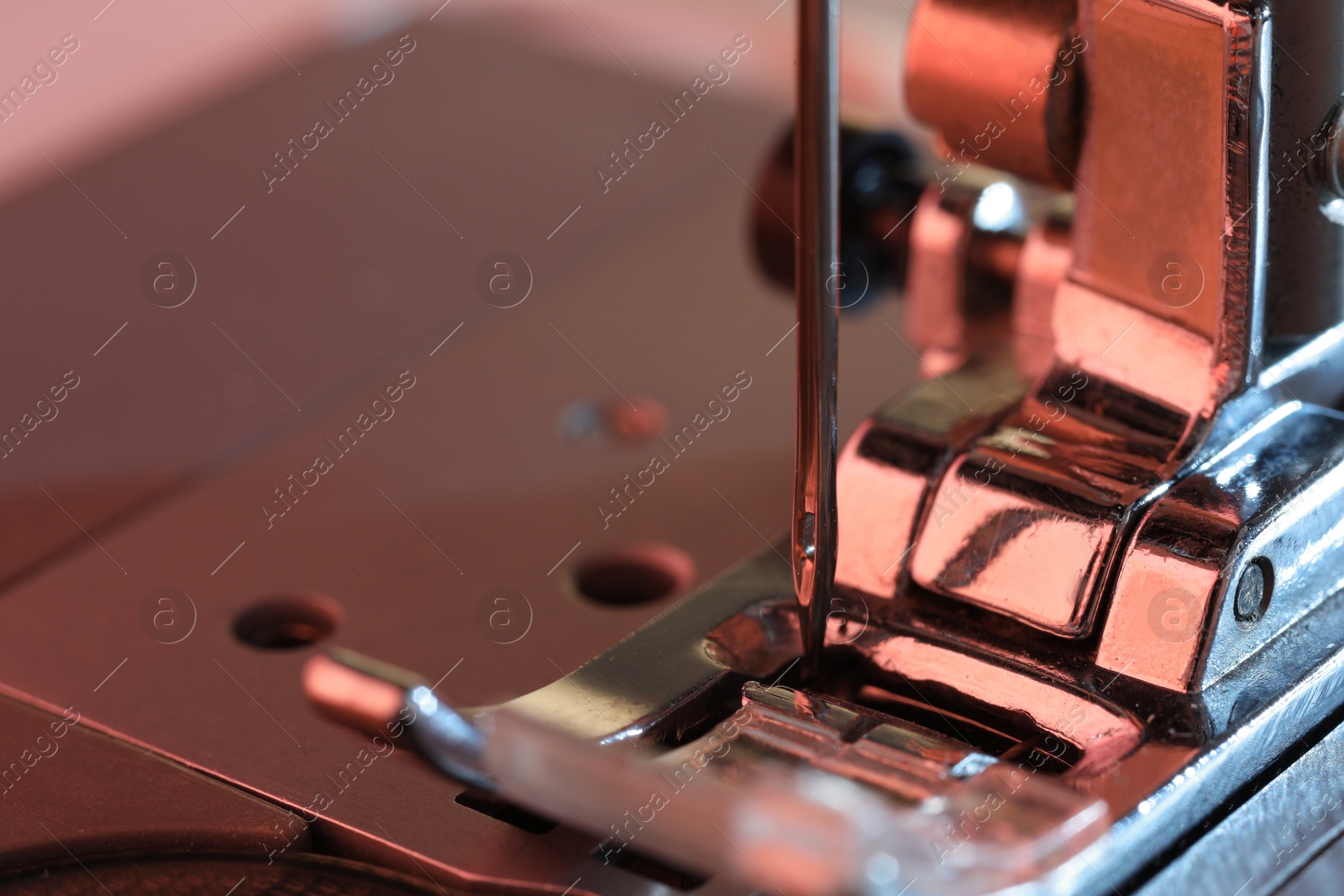 Photo of Macro view of sewing machine with thread. Space for text