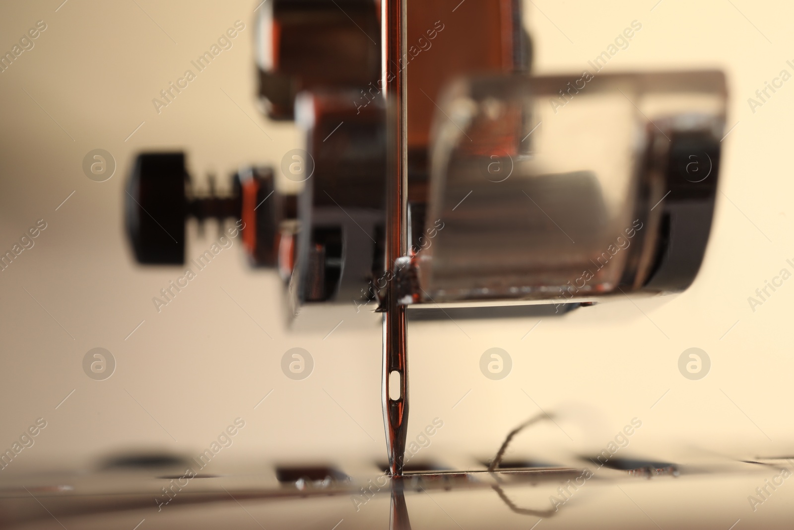 Photo of Sewing machine on light background, macro view