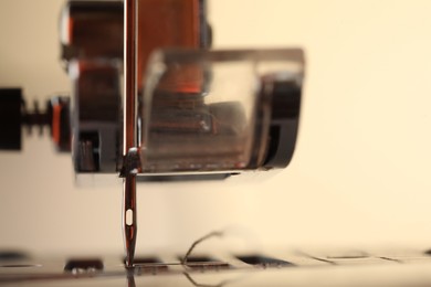 Photo of Sewing machine on light background, macro view. Space for text