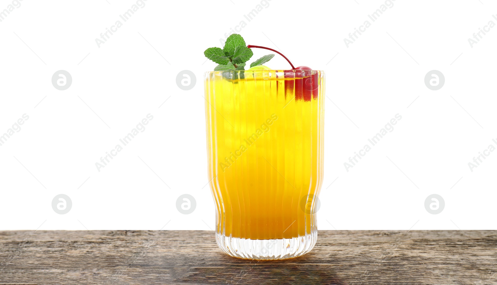 Photo of Tasty pineapple cocktail with mint and cherry in glass on wooden table against white background